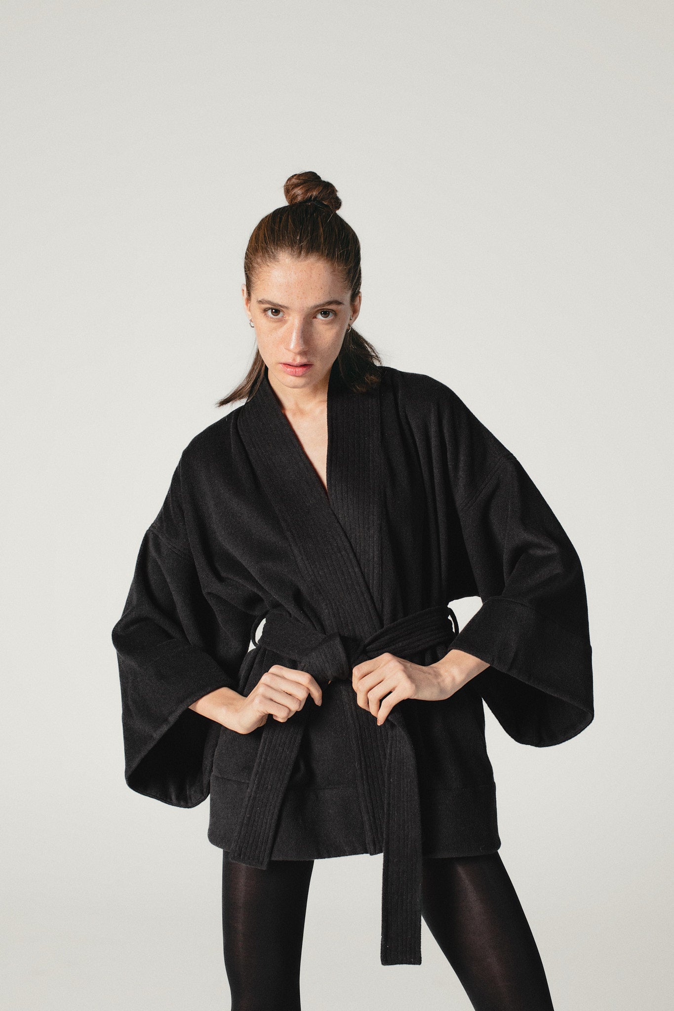 A slightly wild shot of a model wearing a Wool kimono jacket made by Atelier Mizuni