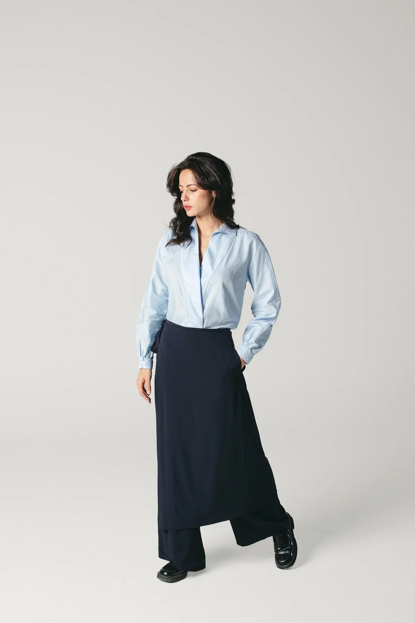 Side view of dark blue wide leg pants with soft drape by Atelier Mizuni