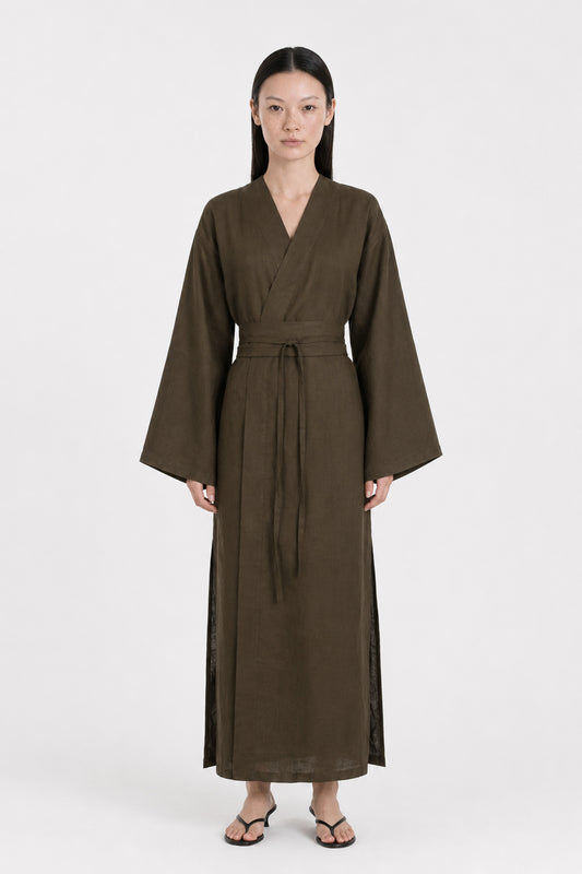 A  model wearing a Dark Olive Linen kimono dress made by atelier mizuni