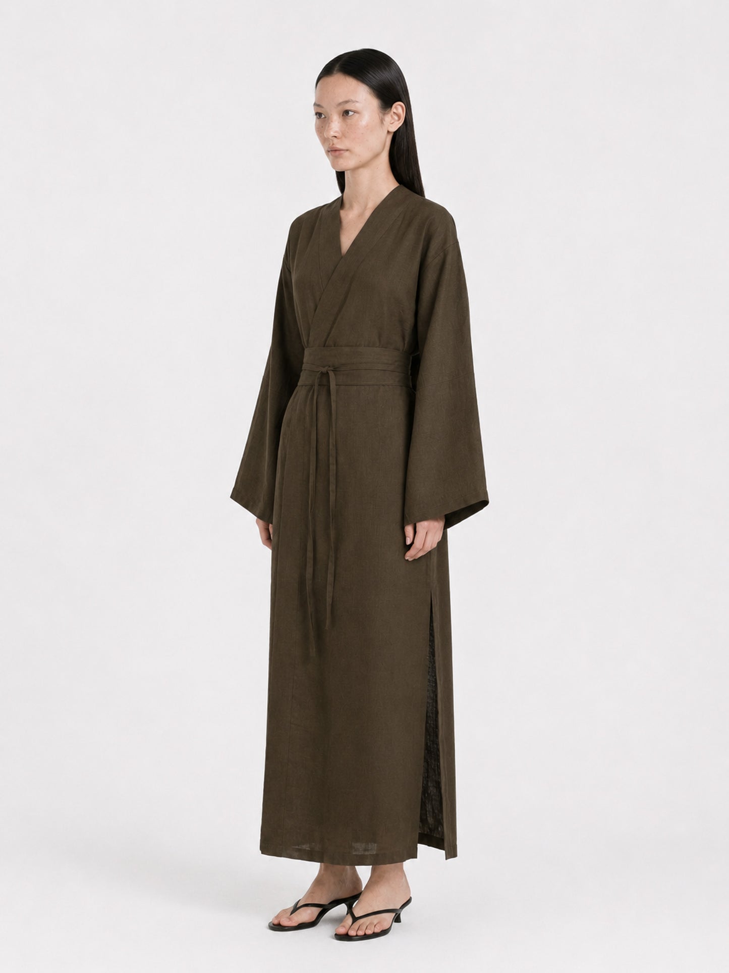 Side shot of a  model wearing a Dark Olive Linen kimono dress made by atelier mizuni