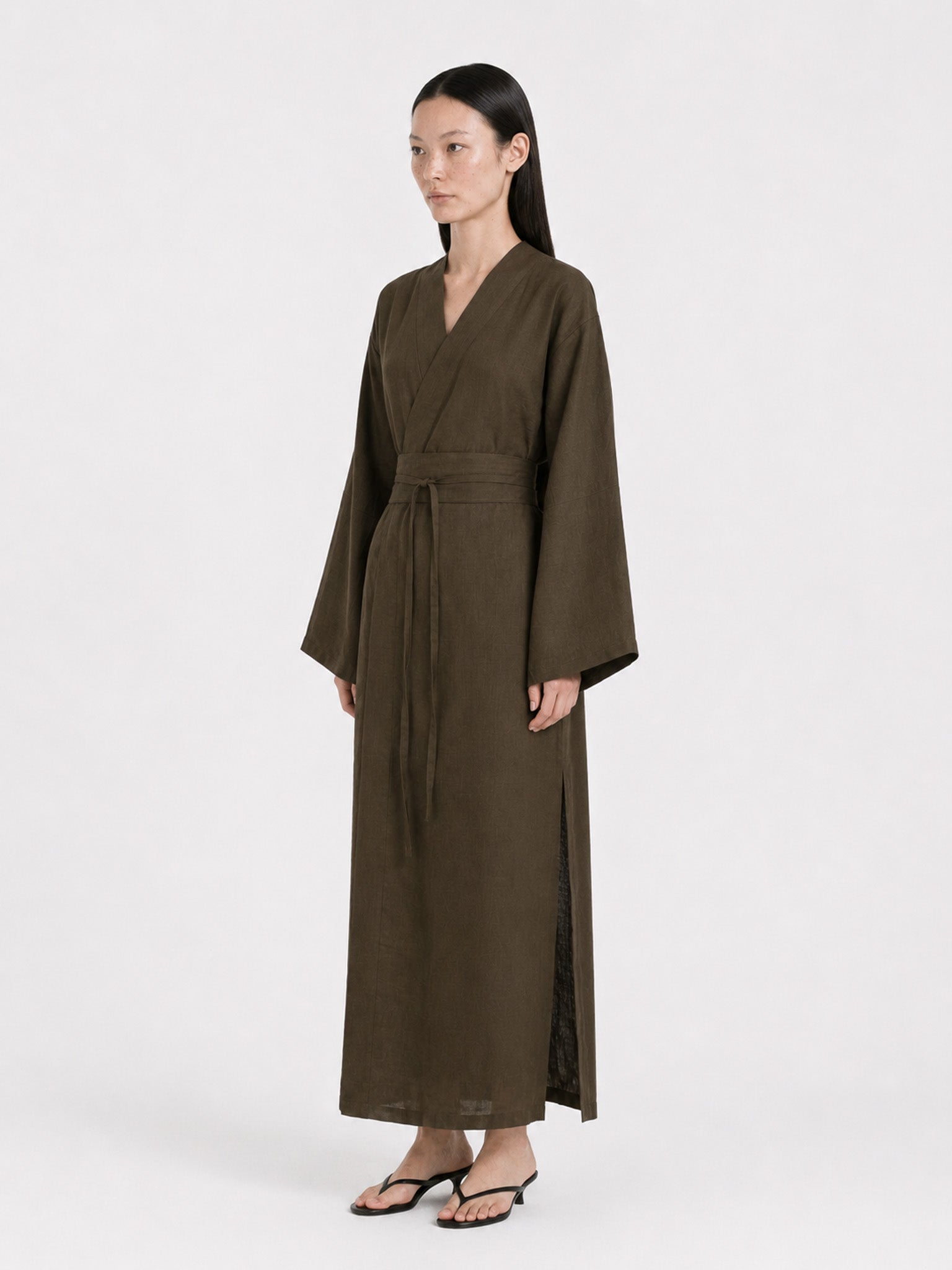 Side shot of a  model wearing a Dark Olive Linen kimono dress made by atelier mizuni