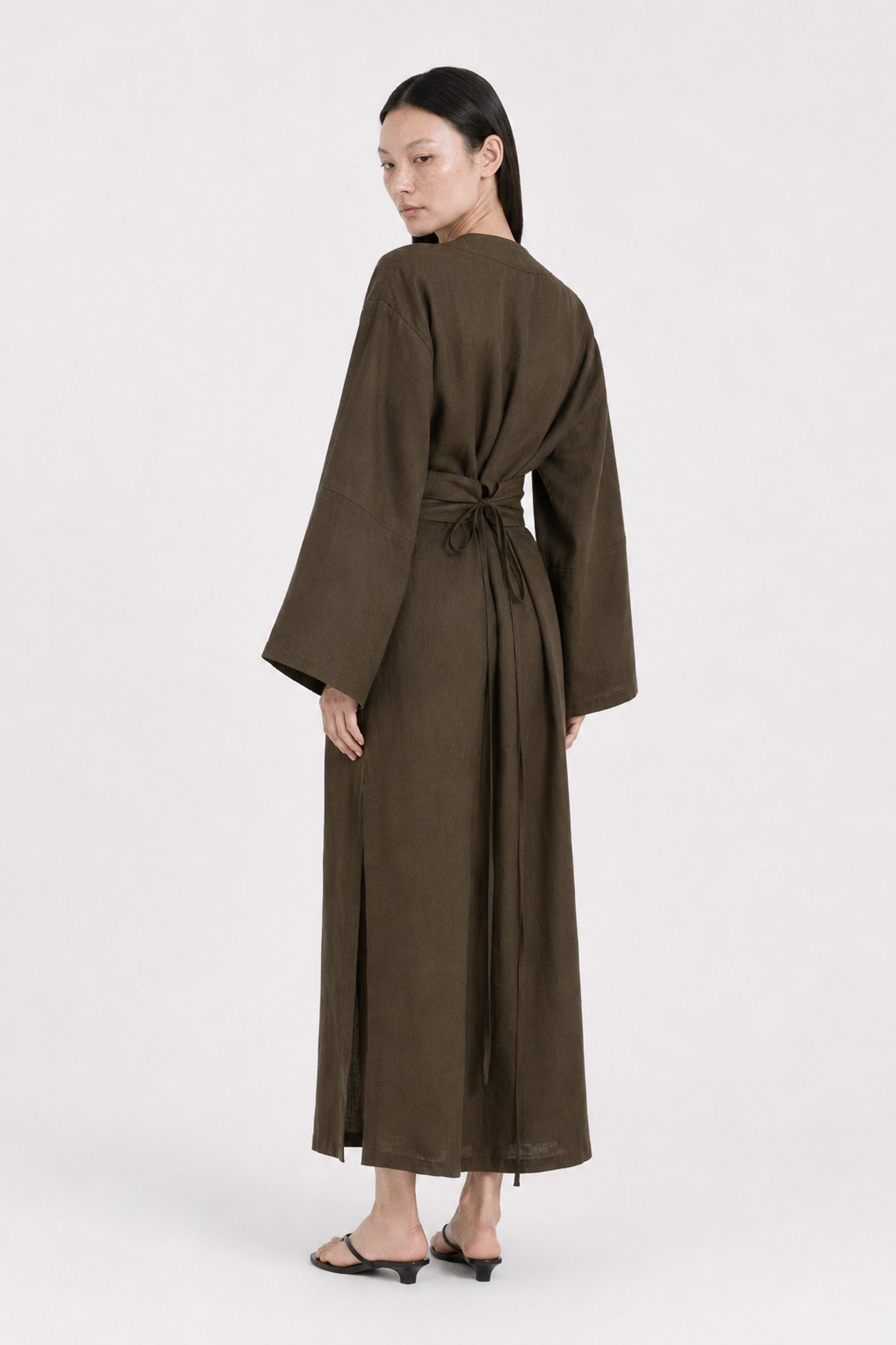 Back shot of a model wearing a Dark Olive Linen kimono dress made by atelier mizuni