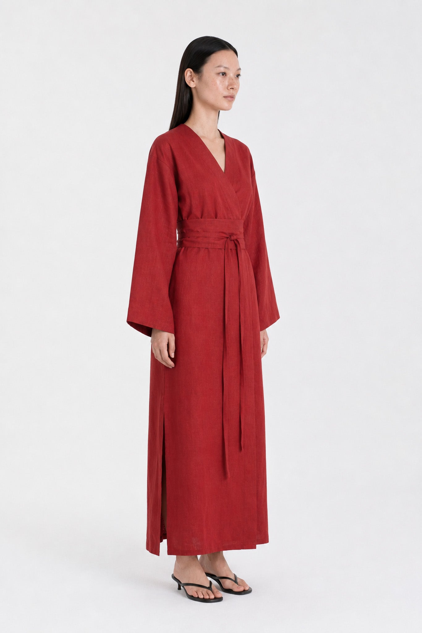 Side shot of a  model wearing a Red Wine linen kimono dress made by atelier mizuni