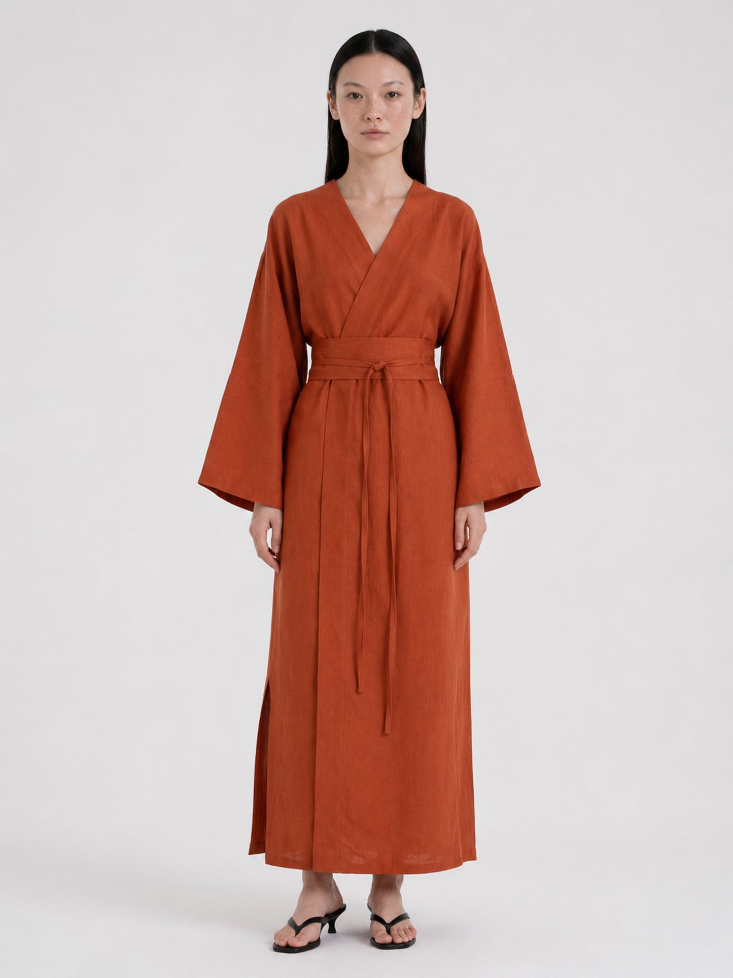 Woman wearing a terracotta kimono dress made of pure linen 