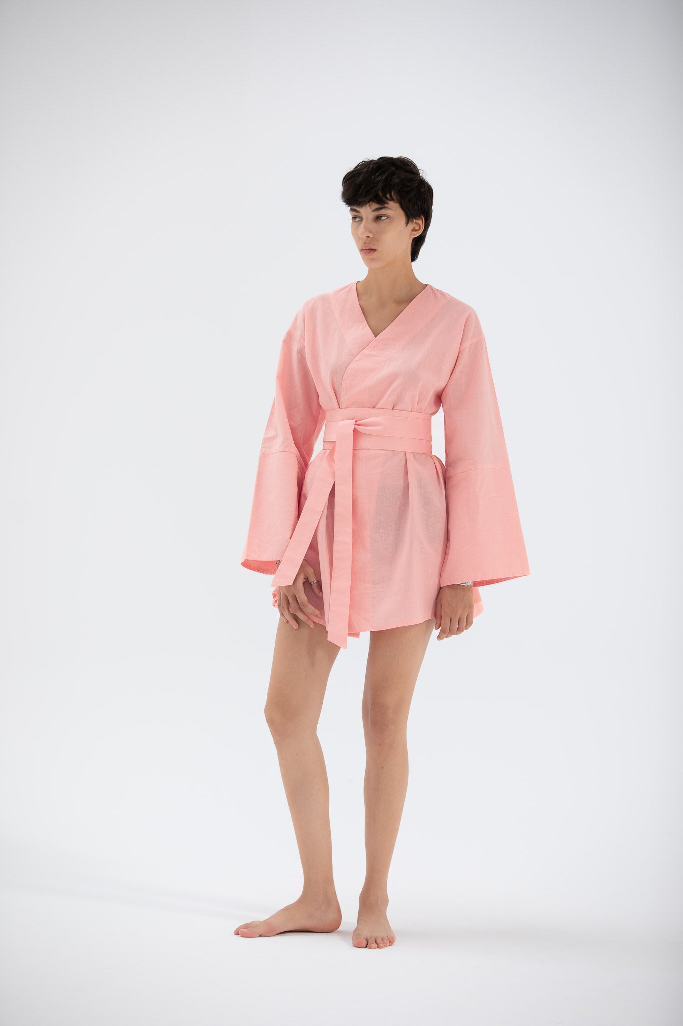 Person wearing a short linen kimono inspired dress by atelier mizuni.