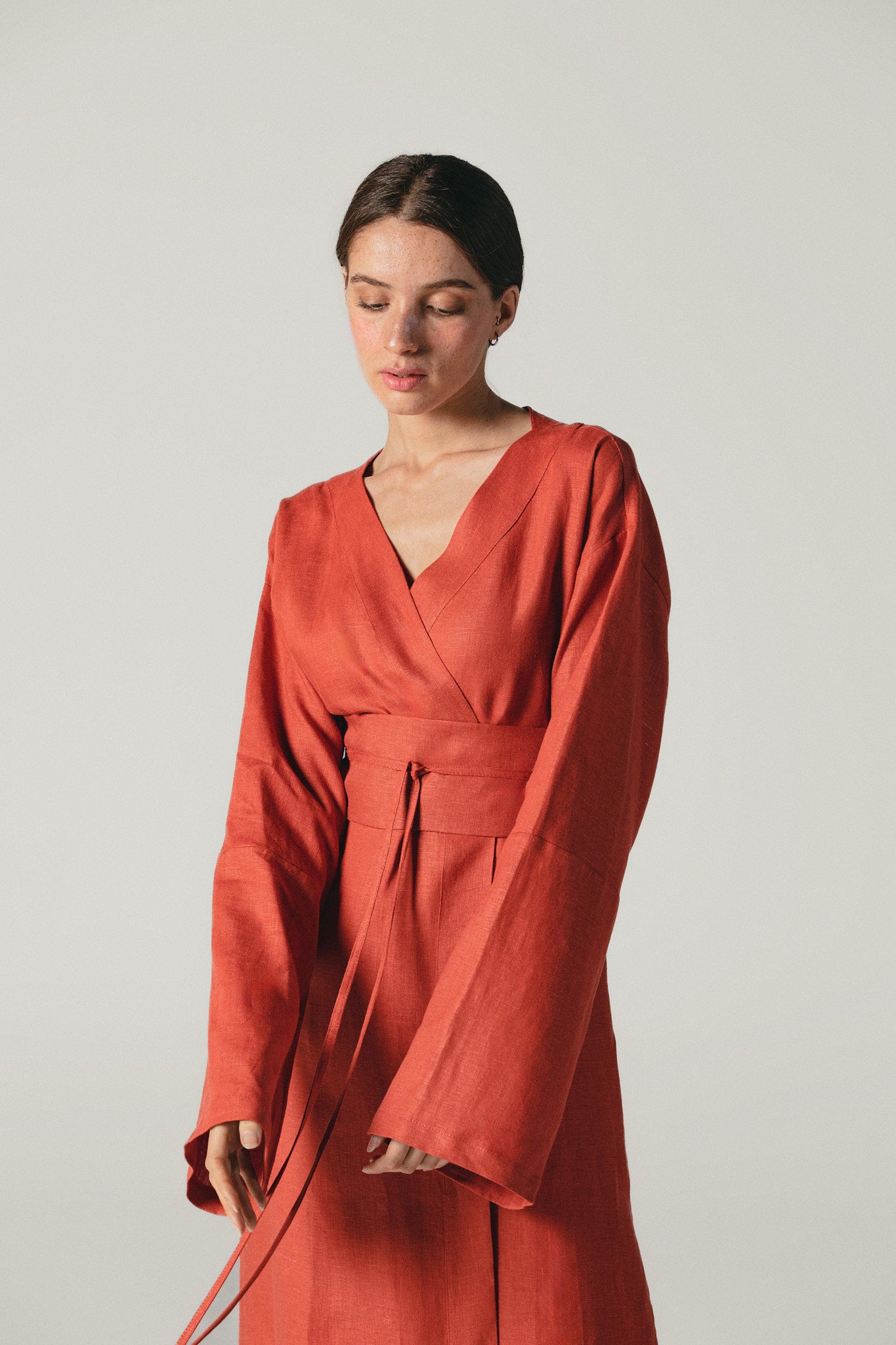 a model wearing a beautiful Terracotta linen kimono dress by atelier mizuni